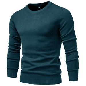 Detail view of a men's slim fit crew neck sweater in dark teal with fine knit texture