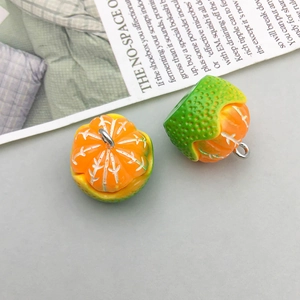 Macro shot of realistic resin orange charms with metal hooks for DIY jewelry making