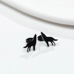Close-up of minimalist matte black wolf stud earrings on a clean white surface