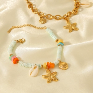Detail of 18k gold ocean bracelets with starfish, colorful beads and natural shells