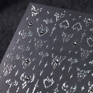 Y2K gothic nail art stickers featuring silver metallic butterflies and stars on dark base