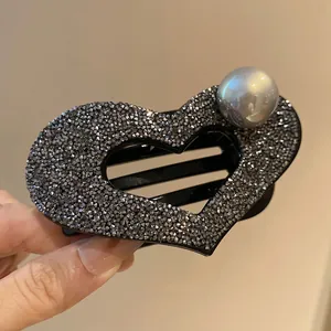 Sparkling black heart hair claw clip with rhinestones and a large grey faux pearl