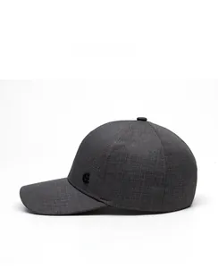 Detail of dark gray baseball cap with textured fabric and side metal letter C emblem