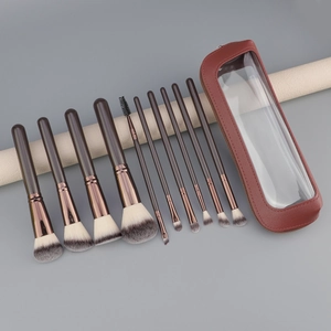 11-piece brown makeup brush set with synthetic bristles and transparent travel pouch