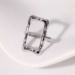 Minimalist silver S925 sterling silver geometric hollow ring on white textured background