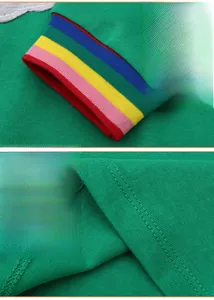 Détail d'un pull en maille verte montrant des poignets arc-en-ciel et un ourlet à double aiguille