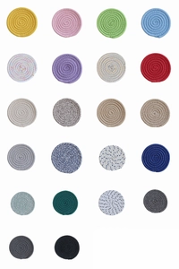 Collection of various colorful round woven cotton coasters in a neat grid display