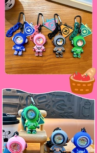 Macro view of colorful astronaut keychains with atmosphere light for backpack and car.