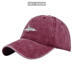 Detailed close-up of a burgundy baseball cap featuring premium 3D shark embroidery and texture