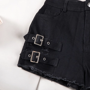 Detail of high waisted black denim shorts with metal side buckles and frayed hem