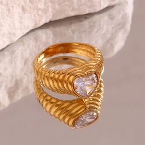 Macro shot of gold-plated heart zircon ring with textured band on stone base