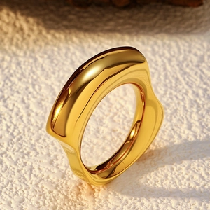 Minimalist wide gold stainless steel ring with an irregular organic wavy design