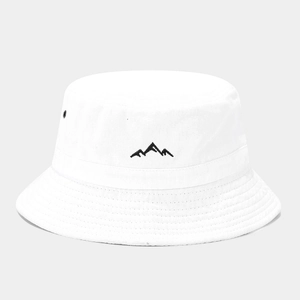 Detail of white cotton bucket hat featuring mountain embroidery and metal air vent hole