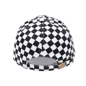 Detail view of the checkerboard baseball cap featuring a retro metal adjustable back buckle