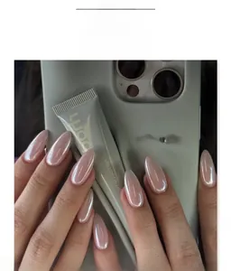 Macro detail of almond-shaped light pink chrome press-on nails with a pearlescent finish