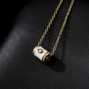 18K gold plated necklace featuring a white enamel cylinder pendant with eye motif