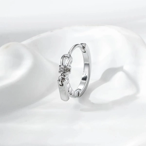 Silver zipper-style earring with sparkling zircon pendant on a clean white background