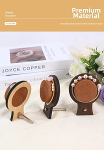 Macro detail of walnut wood jewelry stand with velvet cylinder for bracelet display