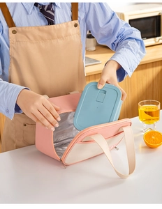 Detail of insulated lunch bag showing silver aluminum foil lining and a blue bento box