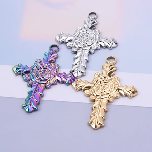 Detailed view of rose engraved cross charms in silver, gold, and rainbow finish