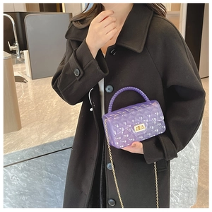 Detail of purple transparent jelly bag with bead handle and gold chain strap