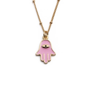Golden Hamsa hand necklace with pink enamel and black eye pendant on white background