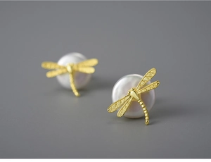 Detailed view of S925 silver dragonfly stud earrings with elegant white pearl details