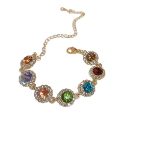 Elegant gold-plated bracelet with multi-colored zircons and adjustable chain on white background