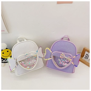 Detail of candy-shaped glitter backpacks with heart windows and iridescent wings