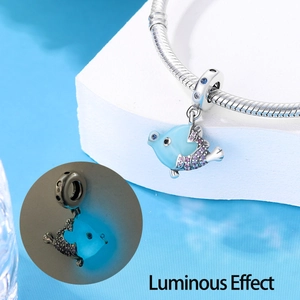 Detailed view of luminous blue fish charm pendant with blue and purple rhinestones