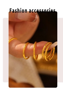 Close-up of multiple stacked 18k gold plated titanium rings with geometric patterns