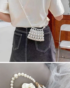 Detailed view of handmade pearl woven mini bag with gold metal clasp and satin lining