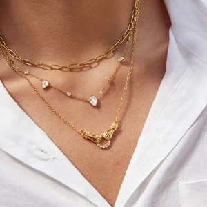 Ensemble de colliers dorés à plusieurs rangs avec zircons goutte d'eau et pendentif mains
