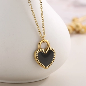 Elegant gold necklace with black heart pendant featuring gear edge and O-chain design