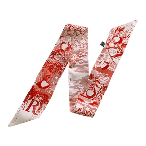 Detail view of a white and red floral Twilly scarf with vintage prints and letter R