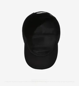 Detail view of the black cotton flat cap featuring a breathable mesh lining and fine stitching