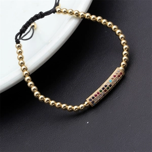 Detailed view of adjustable braided bracelet with colorful zircon micro-pave and gold beads