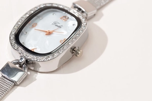 Close-up of elegant oval watch with crystal bezel and mother-of-pearl dial detail