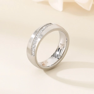 Detailed view of silver ring featuring brushed metal finish and inset crystal rows