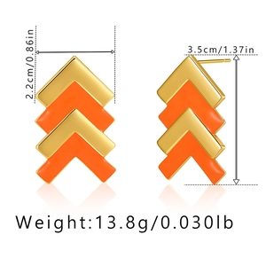 Detailed view of V-shaped gold and orange enamel earrings with size measurements
