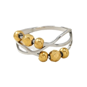 Titanium steel anxiety ring with wavy cutouts and rotatable gold beads on white backdrop