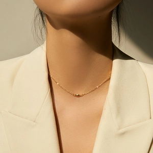 Minimalist 18K gold-plated beaded choker necklace with oval bean pendant on model