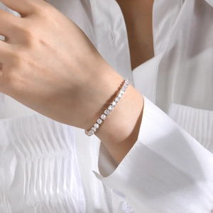 Close-up of sparkling cubic zirconia tennis bracelet worn on wrist with adjustable fit
