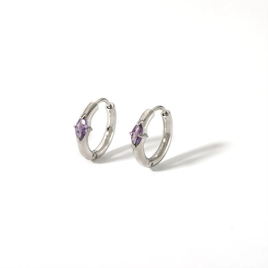 Macro detail of silver hoop earring featuring a marquise-cut purple zircon stone