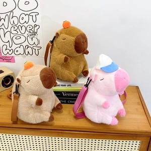 Detailed view of Capybara and pink pig plush crossbody bags with soft texture and straps