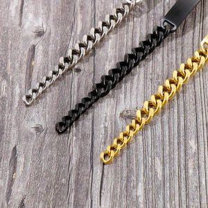 Detailed view of Cuban link bracelets in silver, black and gold finishes on wood
