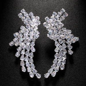 Detailed macro shot of sparkling wing-shaped zircon earrings with silver settings