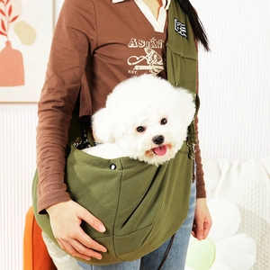 Detail view of army green cotton canvas pet sling carrier worn in a home setting