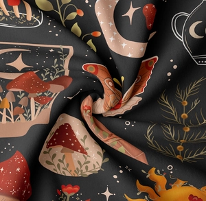 Close-up of mushroom and moon tapestry fabric texture showing print quality and soft drape
