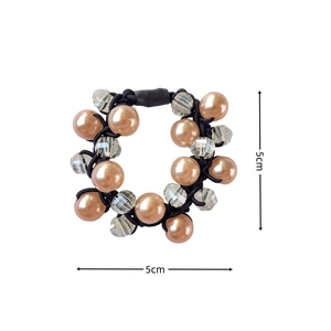 Detail shot of a 5cm elastic hair tie with champagne pearls and crystal beads